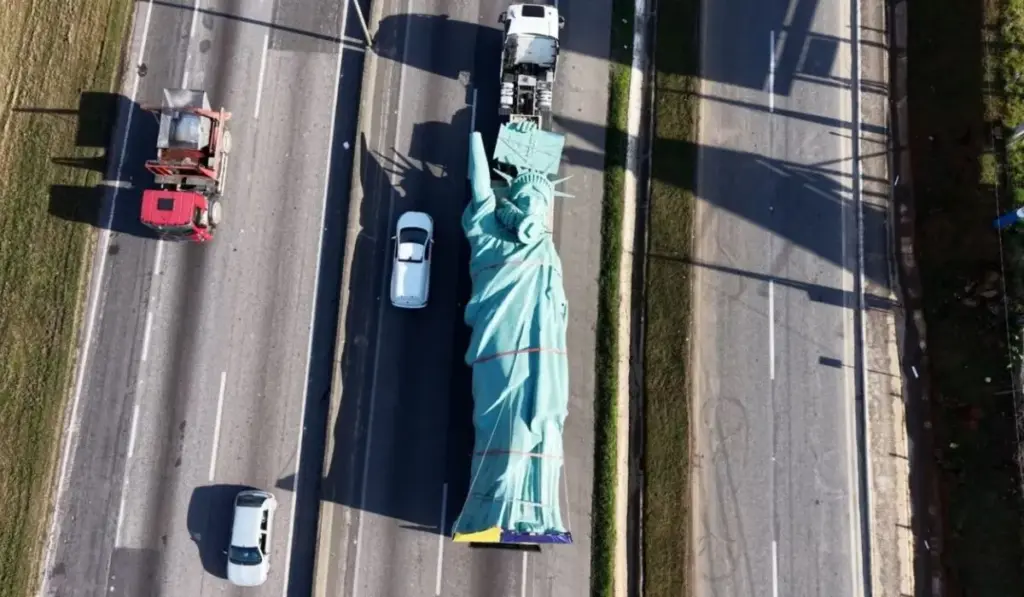 Gigante de 8 toneladas e 24 metros cruza 1,4 mil km de estrada sobre uma carreta até Goiás, onde será içada sobre pedestal para virar Estátua da Liberdade de 35 metros diante de megaloja de R$ 100 milhões da Havan