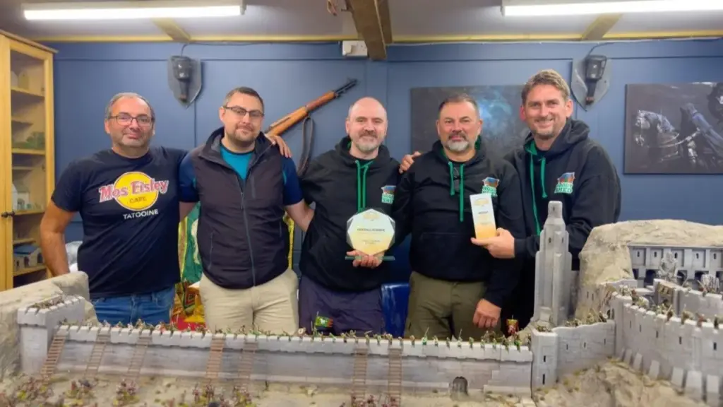 Homem reúne amigos para construir do zero um galpão de jogos com materiais reaproveitados, transforma mesas de pub em piso, cria uma fortaleza de Helm’s Deep em Lego e vence competição nacional com espaço dedicado ao amigo que morreu de câncer antes de conseguir jogar ali com o grupo