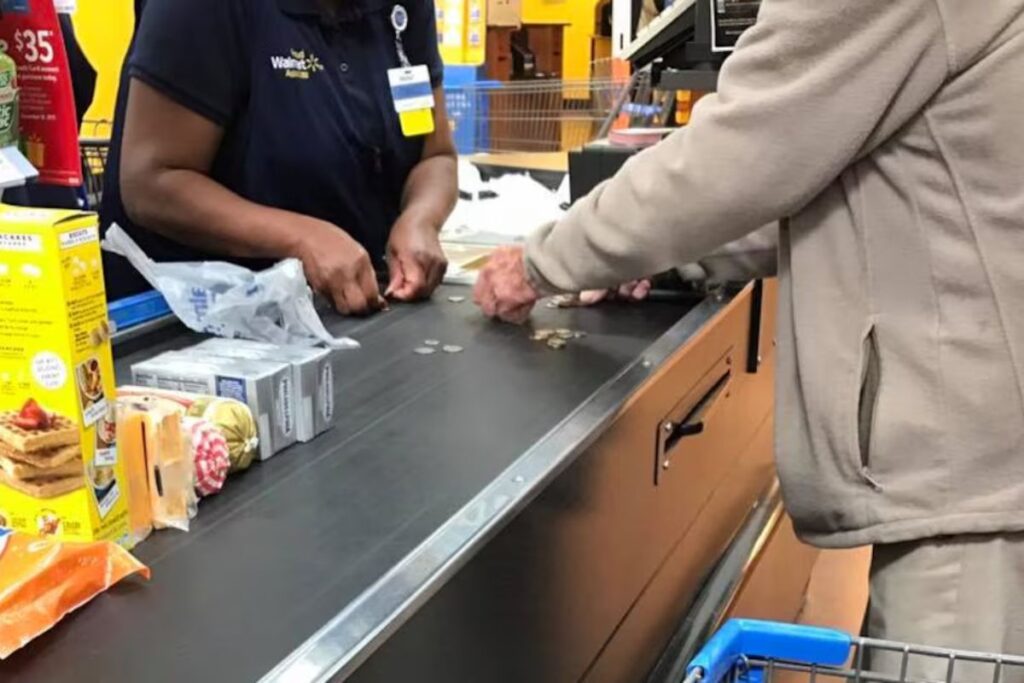 Caixa de supermercado percebe idoso constrangido contando moedas para pagar a compra, para a fila para ajudá-lo moeda por moeda com paciência e se emociona quando o relato do gesto viraliza com o desabafo de que “nos esquecemos de amar”